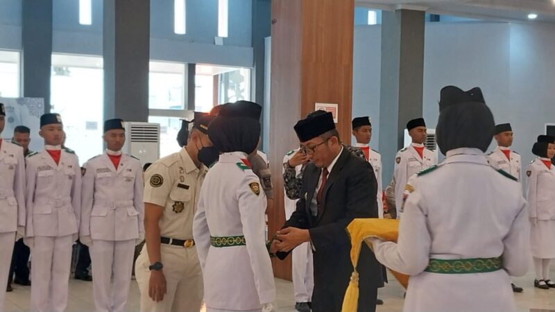 pemasangan kendit kepada perwakilan anggota pasukan Paskibraka Kota Padang. (Diskominfo Padang)