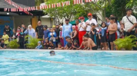 Pj Wali Kota Padang Andree Algamar bersama Ketua TP PKK Padang Ny. Vanny Andree Algamar menyaksikan lomba renang di kolam renang Kawana Hotel, Minggu (25/8/2024). (Foto: Prokopim Padang)