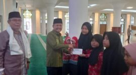 Kabag Kesra Setdako Padang Jasman menyerahkan santunan secara simbolis kepada penerima. (Foto: Diskominfo Padang)