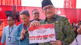 Pj Wali Kota Padang Andree Algamar memperlihatkan surat suara yang digunakan dalam simulasi pemungutan dan penghitungan suara Pilkada serentak, di halaman Kantor Camat Pauh, Kamis (14/11/2024). (Foto: Prokopim Padang)