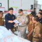 Penjabat (Pj) Wali Kota Padang, Andree Algamar meninjau proses penyortiran dan pelipatan surat suara Pilkada 2024 di Gudang Logistik KPU Padang, Selasa (5/11/2024). (Foto: Prokopim Padang)