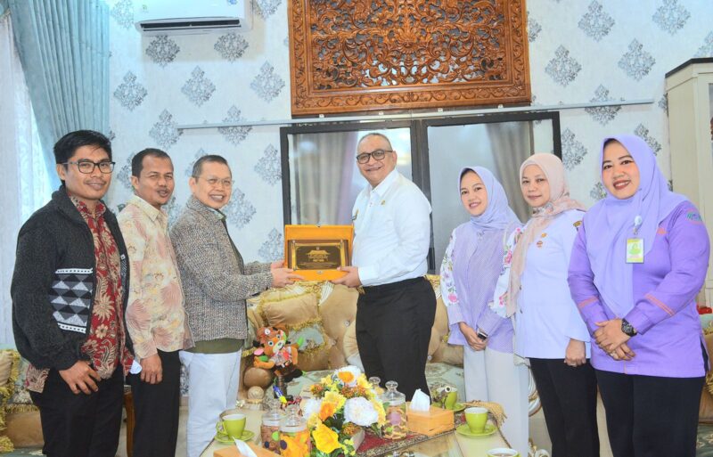 Pj Wali Kota Padang Andree Algamar menyerahkan cenderamata kepada owner RSKM Padang Eye Center. (Foto: Prokopim Padang)