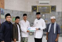 Wali Kota Padang Fadly Amran menyerahkan bantuan kepada pengurus Masjid Raya Balai Gadang, Kecamatan Koto Tangah, Jumat (14/3/2025). (Foto: Prokopim Padang)