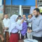 Wali Kota Padang Fadly Amran menyerahkan secara simbolis baju seragam sekolah gratis kepada peserta didik baru di SMPN 2 Padang, Jumat (11/7/2025). (Foto: Prokopim Padang)