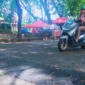 Seorang pengendara sepeda motor tengah melintas di jalan yang sudah ditambal oleh Pemko Padang. (Foto: FB Diskominfo Padang)