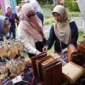 Ketua Dekranasda Padang Panjang, Ny. Maria Feronika Hendri meninjau stand dalam Festival Literasi di PDIKM, Minggu (27/7/2025). (Foto: Kominfo Padang Panjang)