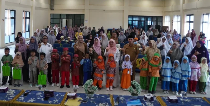Bunda PAUD Padang Panjang, Ny. Maria Feronika menyerahkan bantuan perlengkapan kepada peserta didik PAUD, Senin (28/7/2025). (Foto: Kominfo Padang Panjang)