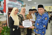 Wakil Wali Kota Padang Maigus Nasir menyerahkan secara simbolis Dana Operasional Triwulan II Tahun 2025 se-Kecamatan Bungtekab, di aula kantor camat setempat, Kamis (17/7/2025). (Foto: Prokopim Padang)