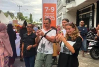 Wisatawan asing mengabadikan momen di Karnaval Kota Tua, Kamis (7/8/2025). (Foto: Diskominfo Padang)