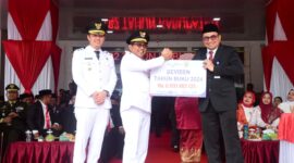 Bupati Padang Pariaman John Kenedy Azis menerima dividen tahun buku 2024 dari Kepala Bank Nagari Cabang Lubuk Alung, Afrizon, SE, Minggu (17/8/2025). (Foto: Kominfo Padang Pariaman)