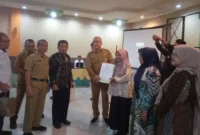 Kepala DPMPTSP Sumbar, Luhur Budianda didampingi Anggota DPRD Sumbar, Bakri Bakar menyerahkan NIB kepada salah satu pelaku usaha. (Foto: Dok. Yoniks)