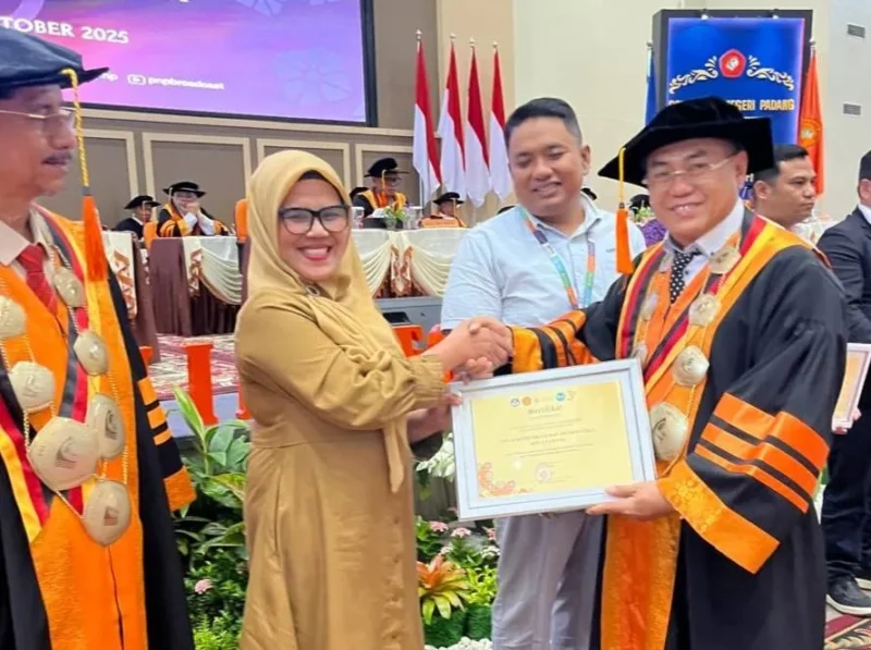 Kepala Bidang Statistik Persandian Diskominfo Padang, Devi Susanti Razif menerima penghargaan dari Direktur PNP, Surfa Yondri, Senin (6/10/2025). (Foto: FB Diskominfo Padang)
