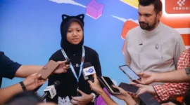 Pengembang gim muda Adelia Misha (kiri) didampingi oleh Presiden AGI Shafiq Husein (kanan) memberikan keterangan kepada awak media di The Stones Hotel, Bali, Sabtu (11/10/2025). (Foto: Ahmad Tri Hawaari/Komdigi)