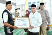 Wakil Wali Kota Padang, Maigus Nasir, menyerahkan secara simbolis dana operasional triwulan III bagi Ketua RT/RW dan lainnya se-Kecamatan Kuranji di Masjid Jami’atul Huda, Jalan By Pass Ketaping, Rabu (29/10/2025). (Foto: Prokopim Padang)
