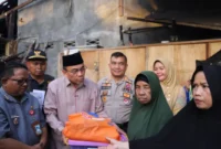 Wakil Wali Kota Padang Maigus Nasir menyerahkan bantuan kepada korban pohon tumbang, Kamis (13/12/2025). (Foto: Prokopim Padang)