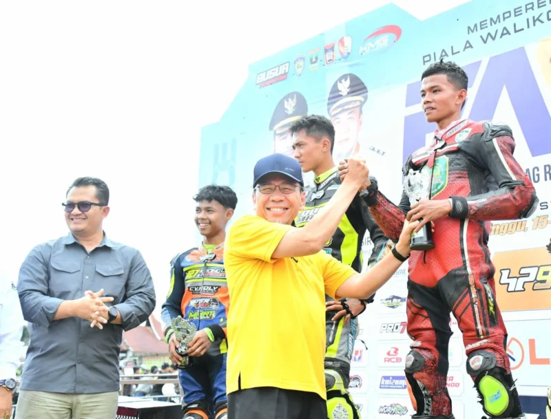 Wakil Wali Kota Padang, Maigus Nasir menyerahkan piala kepada pemenang FAM Road Race Championship, Minggu (16/11/2025). (Foto: Prokopim Padang)