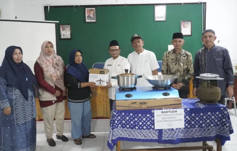 Kepala Dinas Sosial PPKBPPPA Padang Panjang Winarno menyalurkan bantuan kepada 18 KPM yang melaksanakan Graduasi Mandiri PKH 2025 di Aula Dinas Sosial PPKBPPPA, Jumat (21/11/2025). (Foto: Kominfo Padang Panjang)