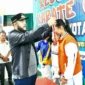 Wali Kota Padang Fadly Amran mengalungkan medali kepada salah satu juara Karate Open Piala Wali Kota Padang 2025, Minggu (16/11/2025). (Foto: Prokopim Padang)