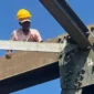 Pekerja melakukan perawatan Jembatan Batanghari Sungai Langkok. (Foto: Kominfo Dharmasraya)
