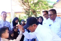 Bupati Padang Pariaman Jhon Kenedy Azis menyerahkan bantuan seragam sekolah gratis kepada siswa, Rabu (24/12/2025). (Foto: Kominfo Padang Pariaman)