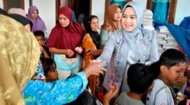 Ketua Dekranasda Kota Padang, Ny Dian Puspita Fadly Amran membawa sejumlah mainan dan bantuan untuk para korban banjir bandang di Posko Bencana Guo, Kecamatan Kuranji, Rabu (3/12/2025). (Foto: Diskominfo Padang)