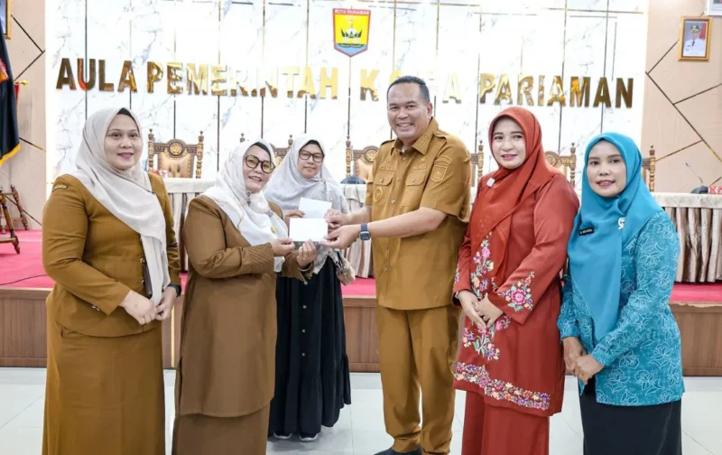 Wali Kota Pariaman Yota Balad saat penyerahan secara simbolis penggantian biaya transportasi kepada kader dasawisma di Aula Balai Kota Pariaman, Senin (15/12/2025). (Foto: Kominfo Pariaman)