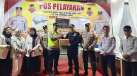 Sekdakab Pasbar Doddy San Ismail menyerahkan bingkisan kepada petugas di pos pengamanan Nataru pada Rabu (24/12/2025) malam. (Foto: Kominfo Pasbar)