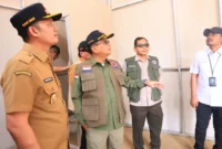 Wakil Bupati Padang Pariaman Rahmat Hidayat mendampingi Sestama BNPB Rustian meninjau progres pembangunan huntara di Kabupaten Padang Pariaman. (Foto: Diskominfo Padang Pariaman)