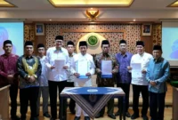 Menag Nasaruddin Umar dan Wakil Ketua Umum Dewan Pimpinan MUI, K.H. Marsudi Syuhud bersama Pejabat dan Pimpinan Kemenag dan MUI dalam giat penandatanganan MoU mengenai Implementasi KUHP dan KUHAP. (Foto: Firmandan Wijaya/Kemenag)