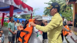 Asisten Pemerintahan dan Kesejahteraan Rakyat Kota Pariaman, Elfis Chandra menyerahkan life jacket kepada pelaku usaha kapal wisata di Panggung Utama Pantai Gandoriah, Minggu (29/3). (Foto: Kominfo Pariaman)