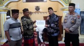 Bupati Pessel, Hendrajoni saat menyerahkan bantuan untuk pembangunan Masjid Thoiyibah, kepada ketua pengurus Masjid, Syahrial. (Foto: Dok. Niks)