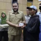 Wali Kota Padang Fadly Amran menyalurkan bantuan stimulan perbaikan rumah bagi masyarakat terdampak bencana hidrometeorologi di Kota Padang, Selasa (28/4/2026). (Foto: Prokopim Padang)