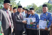 Wakil Wali Kota Padang Maigus Nasir menyerahkan penghargaan/sertifikat Stratifikasi Standar UKS/M kepada sekolah dari berbagai jenjang pendidikan. (Foto: Diskominfo Padang)