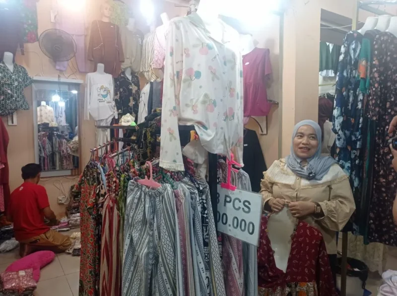 Pedagang menunjukkan koleksi pakaian yang dijual di Pasar Raya Padang Fase VII. (Foto: Diskominfo Padang)