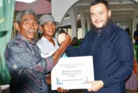 Wali Kota Padang Fadly Amran menyerahkan bantuan benih padi bersertifikat kepada kelompok tani. (Foto: Pemko Padang)