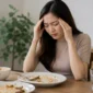 Ilustrasi Wanita mengalami sakit kepala setelah makan. (Foto: AI Generate)