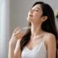 Ilustrasi seorang wanita mengenakan parfum. (Foto: AI Generate)