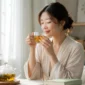 Ilustrasi wanita meminum teh herbal. (Foto: AI Generate)