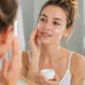 Ilustrasi wanita mengoleskan moisturizer ke wajah. (Foto: AI Generate)