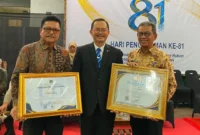 Asisten Pemerintahan dan Kesra Setda Kota Padang, Tarmizi Ismail saat menerima penghargaan mewakili Wali Kota dan Wakil Wali Kota Padang. (Foto: Pemko Padang)