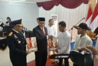 Kepala Kanwil Ditjenpas Sumbar Kunrat Kasmiri dan Sekdaprov Sumbar Arry Yuswandi menyerahkan remisi umum HUT ke-81 RI di Rutan Kelas IIB Padang, Senin (17/8/2026). (Foto: Ist)