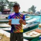 Salah seorang nelayan di Kepulauan Seribu memperlihatkan undangan dari Presiden Prabowo untuk menghadiri Upacara HUT ke-81 Kemerdekaan RI di Istana Merdeka pada 17 Agustus 2026. (Foto: BPMI Setpres)