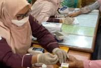Petugas kesehatan memberikan pelayanan cek kesehatan gratis kepada warga. (Foto: Pemko Padang)
